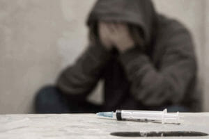 Addict Struggling With Heroin Withdrawal Symptoms