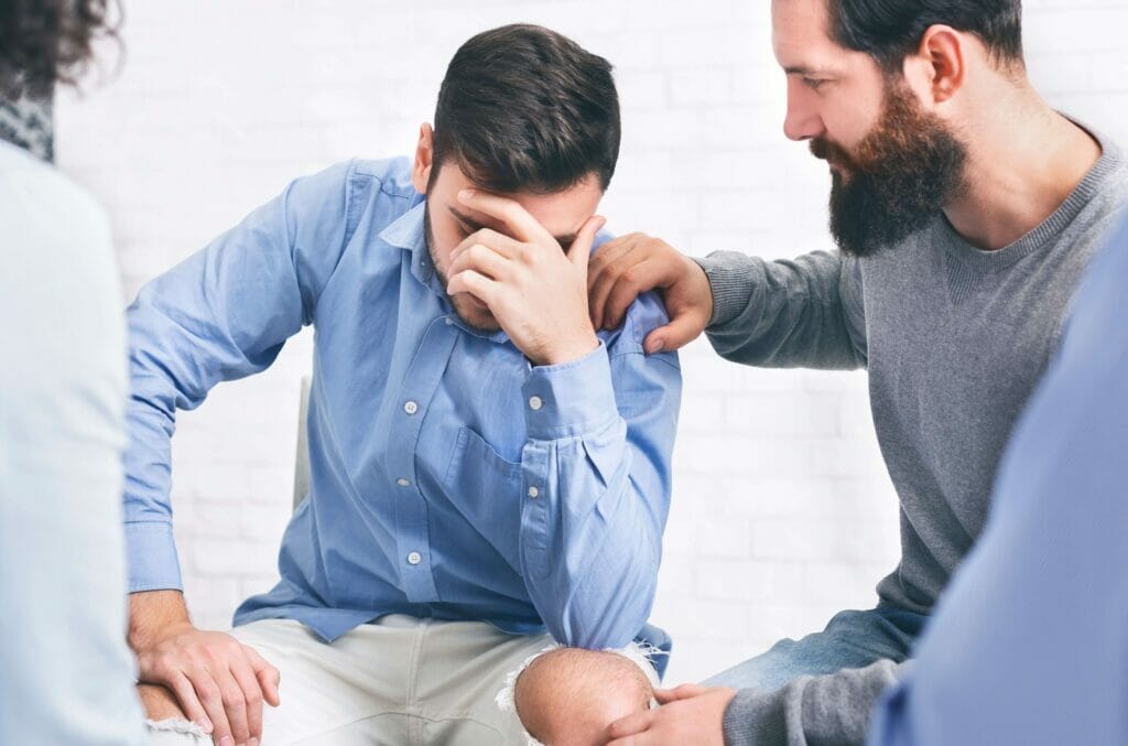 man confronting an addict and offering support