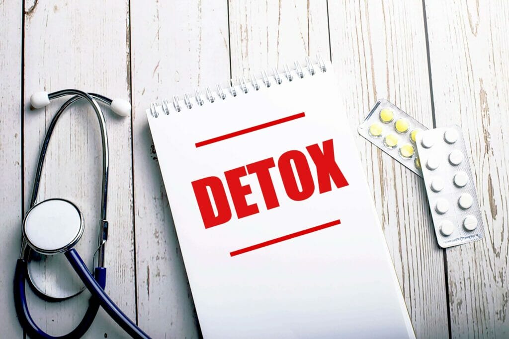 detox written on medical notebook next to a stethoscope